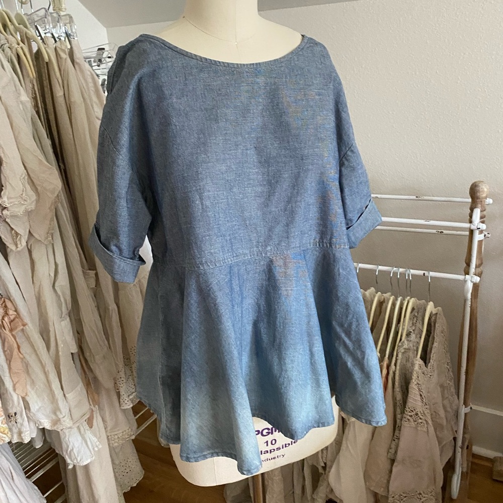 Light denim peplum top.